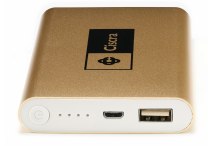 A large flat power bank in gold coloured metal