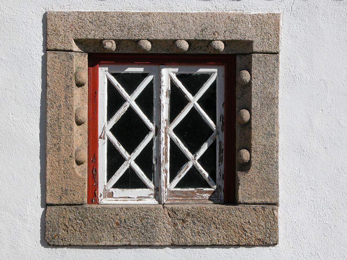 A Square window with a carved granite surround in Marvao
