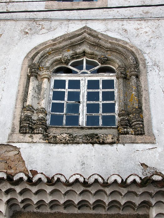 An ornate granite window surround on a delapidated building in Marvao