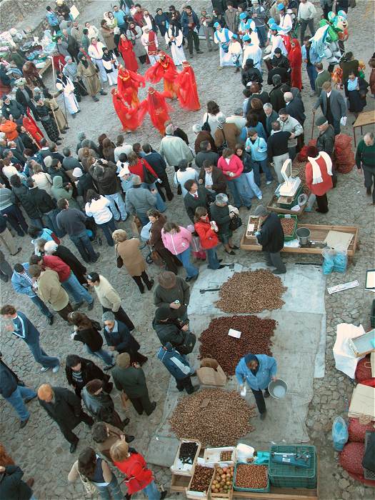 Traditional dancers and chestnut vendor at the Marvao Chestnut Festival in Portugal