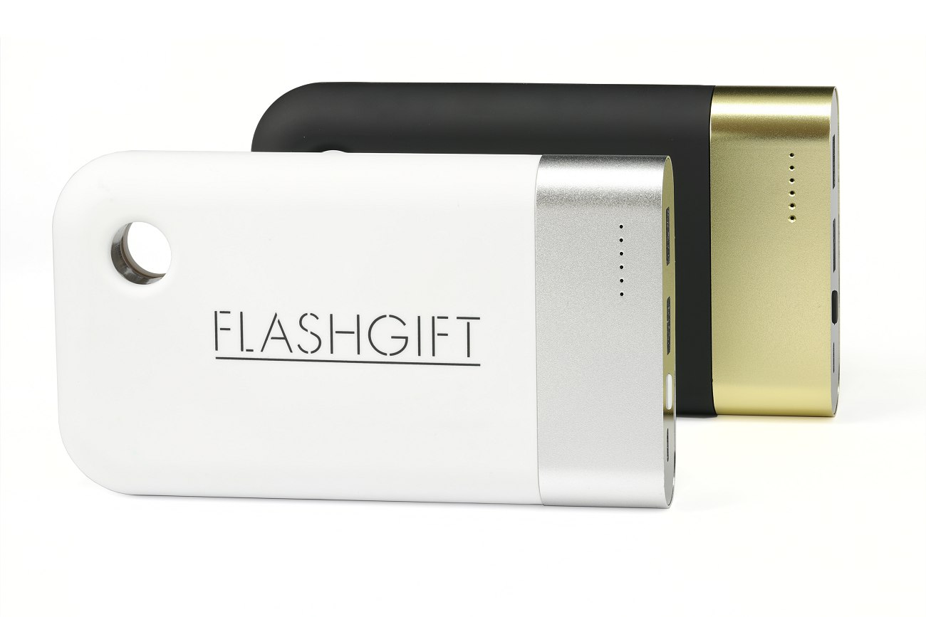 A large white power bank with silver metal band in front of a black one with a gold metal band